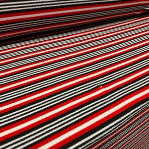 May include: Red, black, and white striped fabric with a ribbed texture.