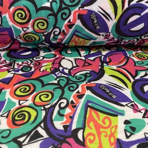 May include: White fabric with a colorful abstract print featuring swirls, geometric shapes, and the word "Holiness" repeated. The print is in shades of pink, green, blue, yellow, and black.