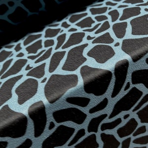 May include: Close-up of a blue and black fabric with a textured, irregular pattern resembling animal skin.
