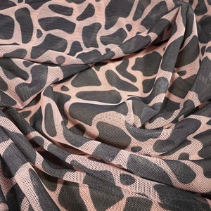 May include: Pink and black mesh fabric with a black animal print pattern.