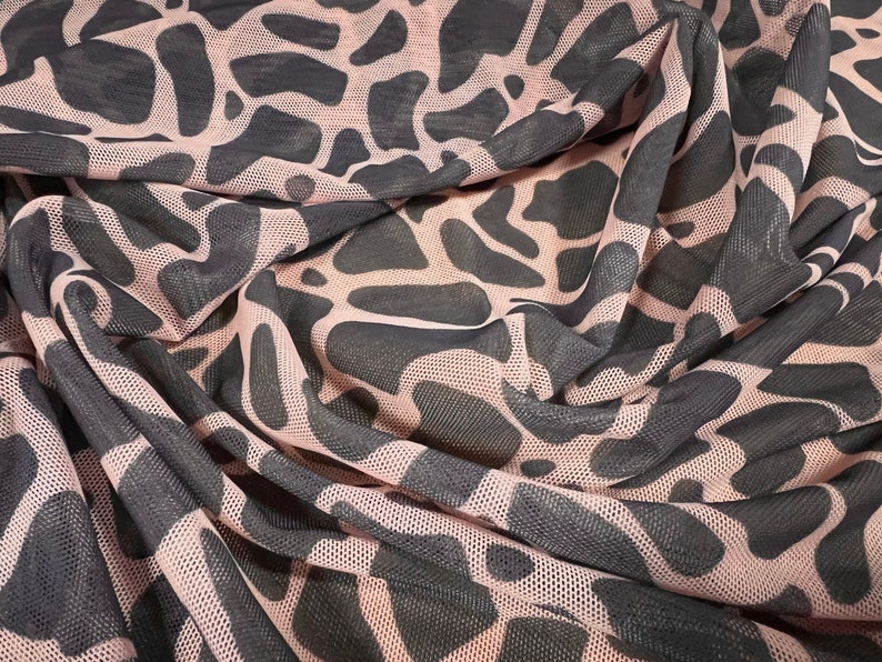 May include: Pink and black mesh fabric with a black animal print pattern.