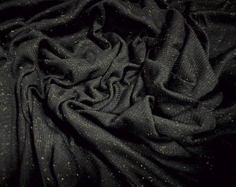 May include: Black fabric with a subtle shimmer, creating a textured and luxurious look. The fabric is draped and folded, showcasing its soft and flowing nature.