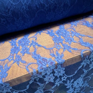 May include: Blue lace fabric with a floral pattern. The lace has a subtle shimmer.