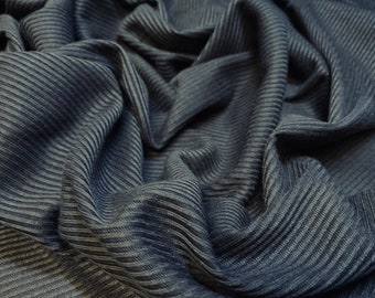 May include: Close-up of a dark gray ribbed fabric with a textured surface.