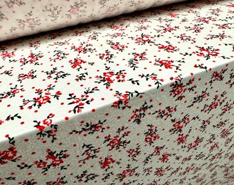 May include: White fabric with a repeating pattern of small red flowers and black stems on a white background with small red dots.