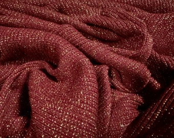 May include: Close-up of a burgundy fabric with a subtle shimmer. The fabric has a ribbed texture and a soft, luxurious feel.