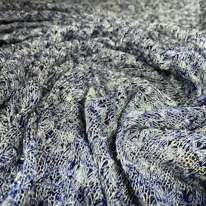 May include: Close-up of a blue and white knitted fabric with a textured, open weave pattern.