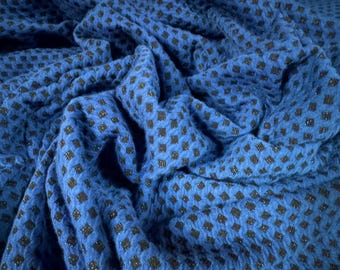 May include: Blue fabric with a black diamond pattern. The fabric has a textured, slightly glittery surface.