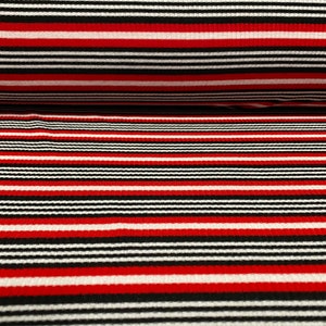 May include: Red, black, and white striped fabric with a ribbed texture. The fabric is woven with horizontal stripes.