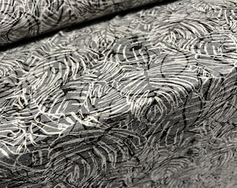 May include: Black and white abstract patterned fabric with a textured surface.