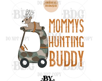 May include: A brown and white deer cartoon character riding in a camouflage-patterned golf cart. The text "Mommy's Hunting Buddy" is written in orange and brown letters.