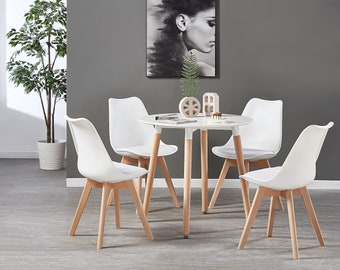 Modern dining set with white or black round table and 4 Pyramid style plastic chairs with padded seating in a Scandinavian design