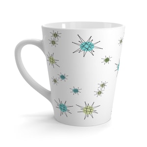 May include: White ceramic latte mug with a mid-century modern design featuring a repeating pattern of black, blue, and green stars.