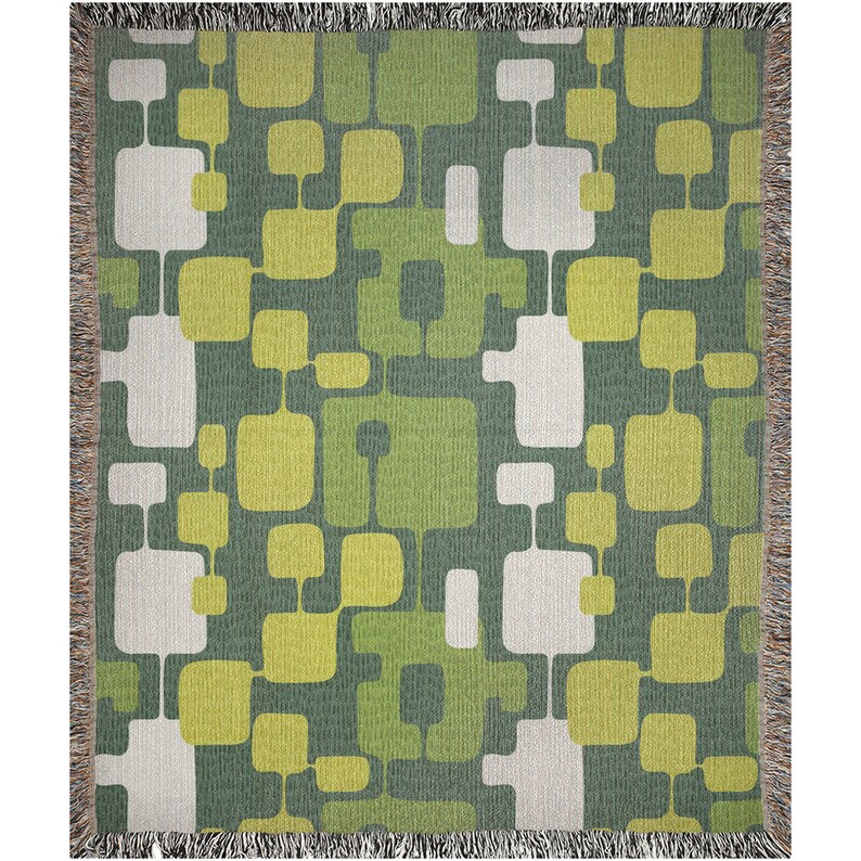 May include: A woven throw blanket with a geometric pattern in shades of green and white. The pattern features squares and rectangles of various sizes.