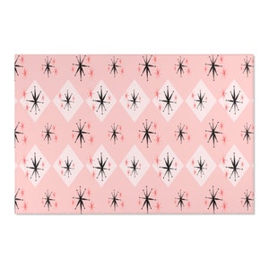 May include: Pink and white geometric pattern wrapping paper with a repeating design of black stars.