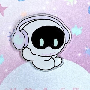 May include: A white robot with a black face and blue eyes wearing lavender headphones. The robot is sitting with its legs crossed. The background is a light pink with white glitter.
