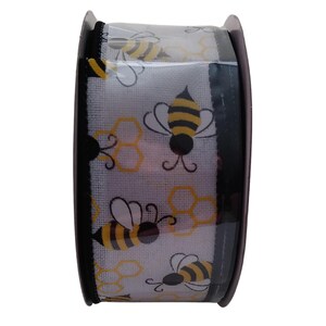 May include: A roll of white ribbon with a black border and a repeating pattern of yellow and black bees and honeycombs.