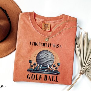 a t - shirt that says i thought it was a golf ball