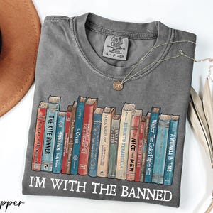 a t - shirt with a bunch of books on it