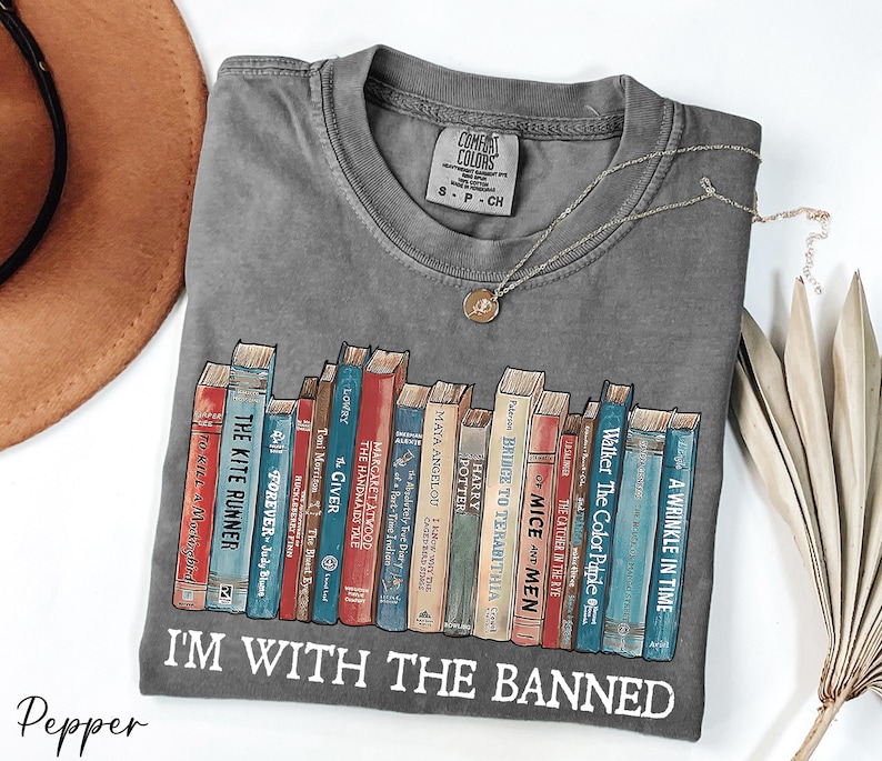 a t - shirt with a bunch of books on it