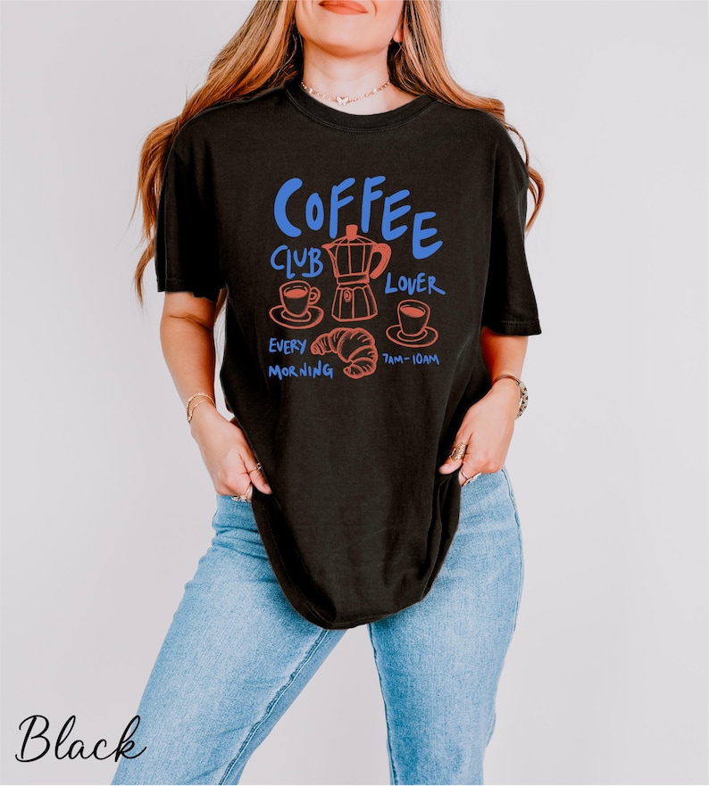 a woman wearing a black coffee shirt
