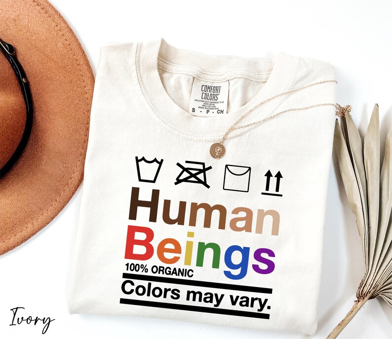a hat, sunglasses, and a t - shirt with the words human beings on