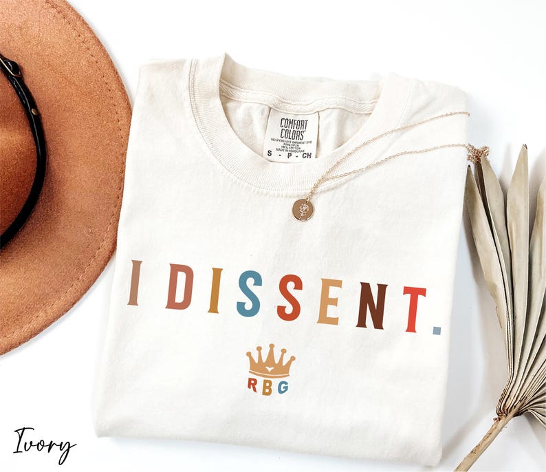 a hat, sunglasses, and t - shirt on a white surface