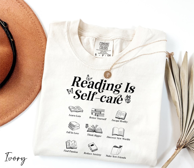 a hat, sunglasses, and t - shirt that says reading is self - care