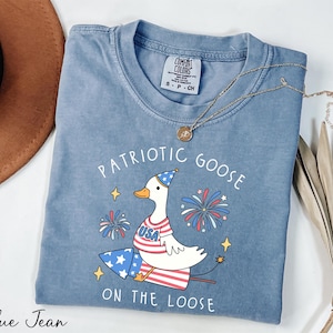 a blue shirt with a patriotic goose on the loose