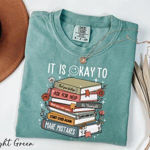 a t - shirt that says it is okay to ask for help