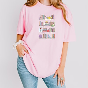 a woman wearing a pink shirt and jeans