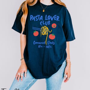a woman wearing a t - shirt that says pasta lover club