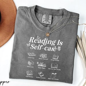 a t - shirt that reads reading is self - care
