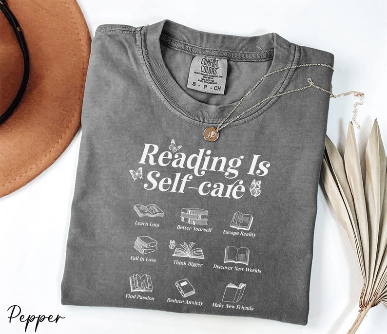 a t - shirt that reads reading is self - care