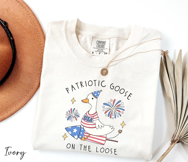 a white shirt with patriotic goose on the loose