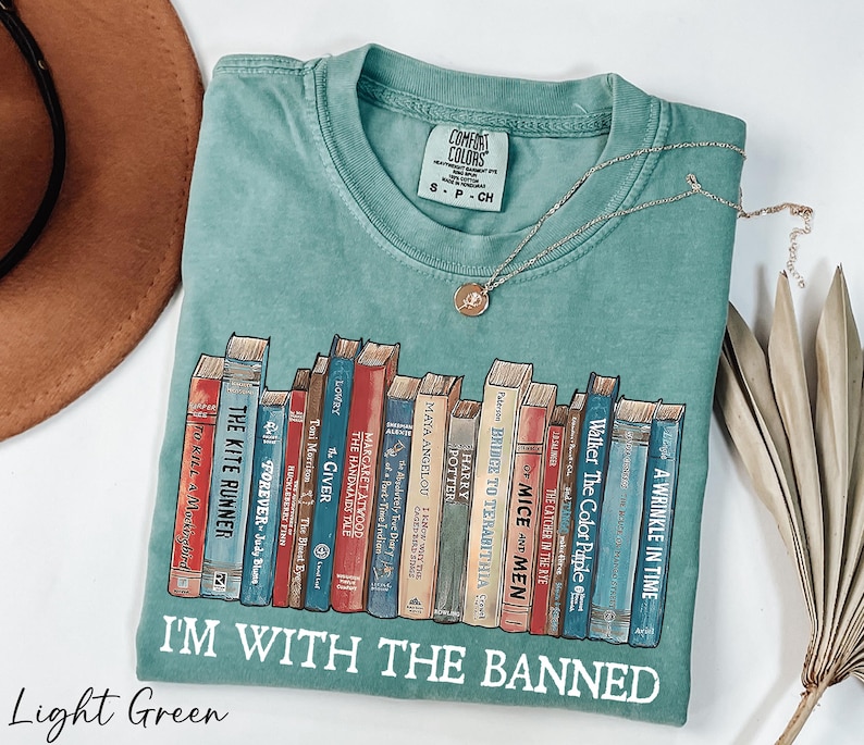 a t - shirt with a bunch of books on it