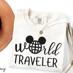 a hat, sunglasses, and t - shirt with the word world traveler on it