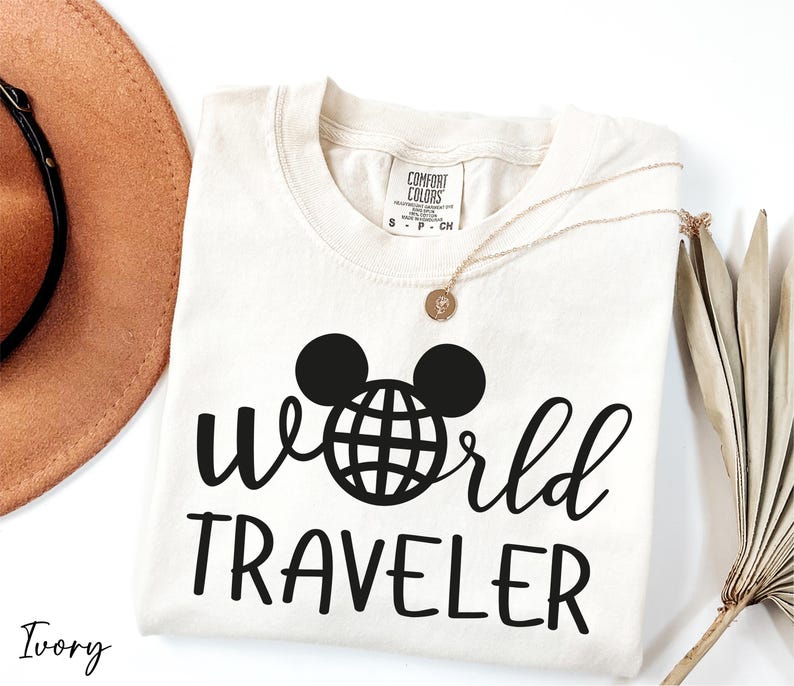 a hat, sunglasses, and t - shirt with the word world traveler on it