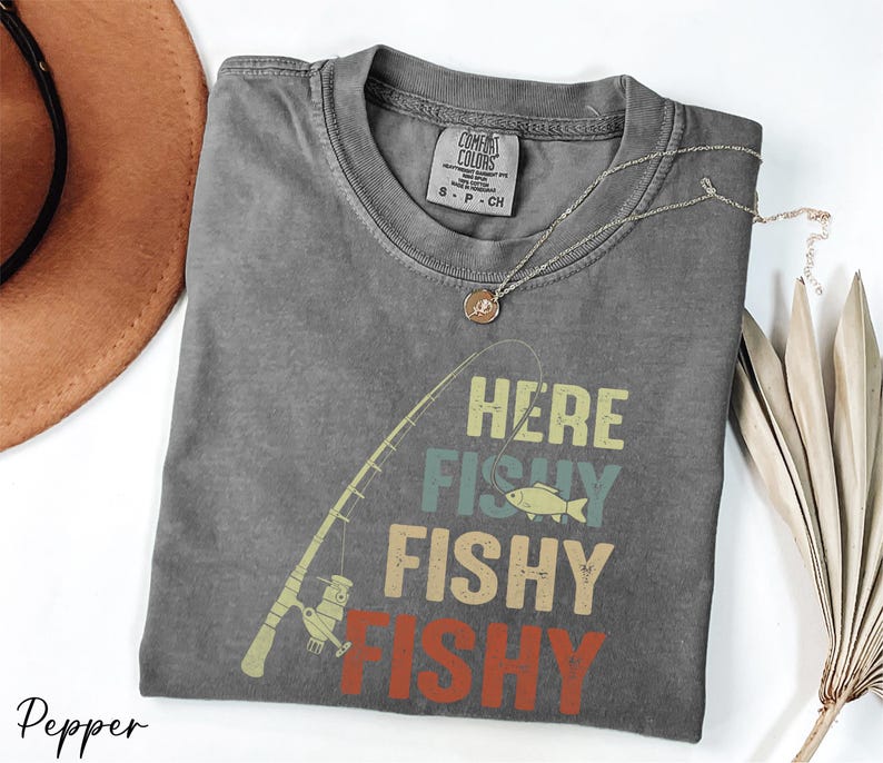 a t - shirt with a fishing design on it