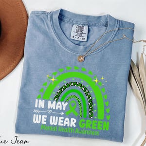 a blue tshirt with a green design on it