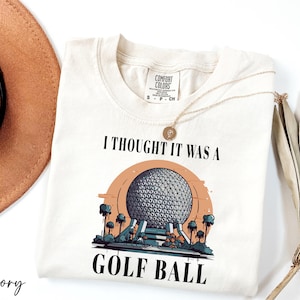 a t - shirt that says i thought it was a golf ball
