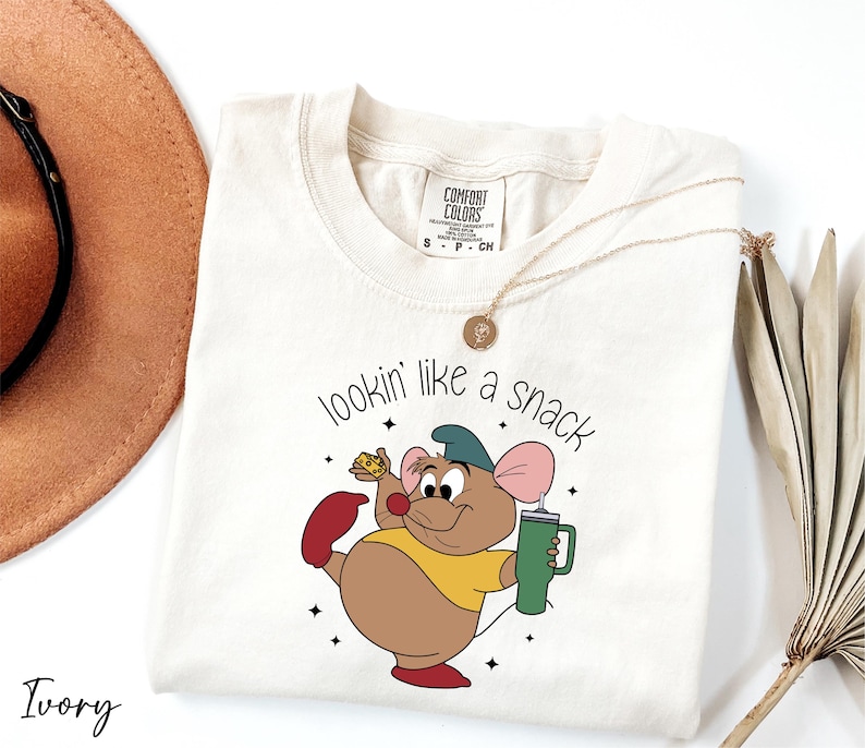 a t - shirt with a cartoon mouse holding a cup of coffee