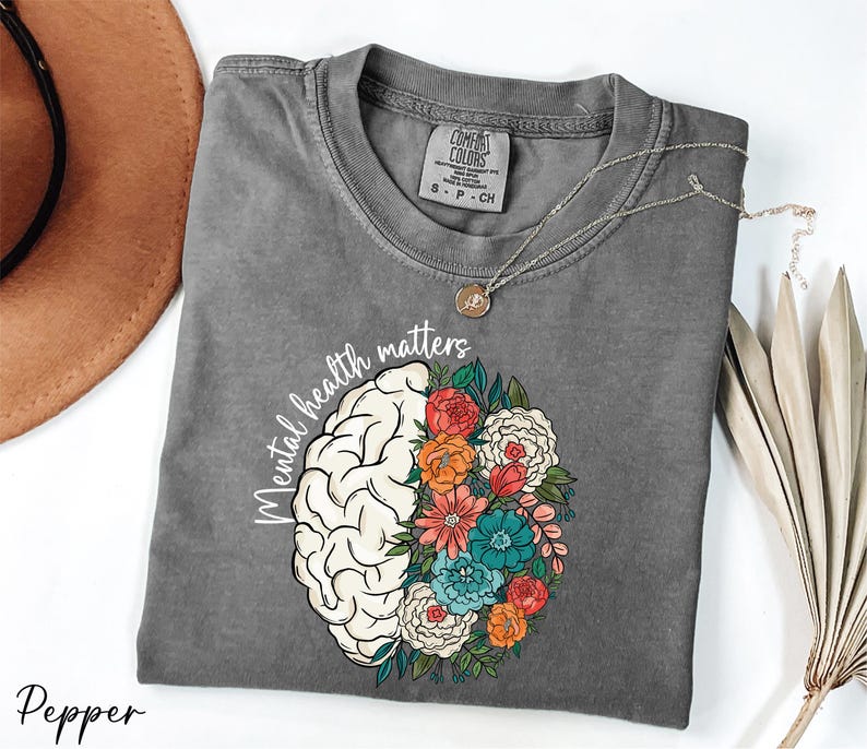 a t - shirt with a picture of a brain and flowers on it
