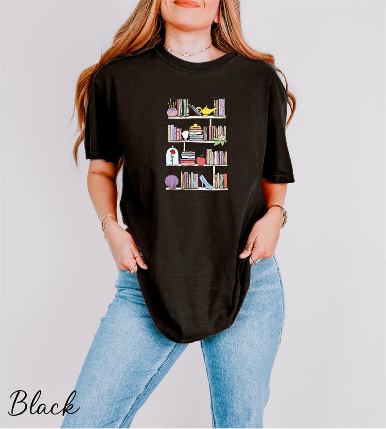 a woman wearing a black t - shirt with books on it