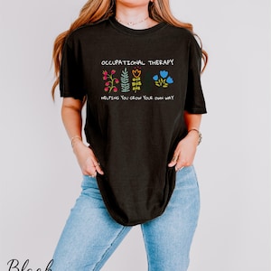 a woman wearing a black t - shirt with a floral design