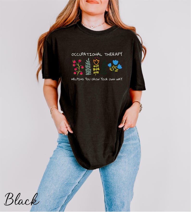a woman wearing a black t - shirt with a floral design