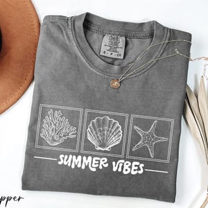 a t - shirt that says summer vibes on it