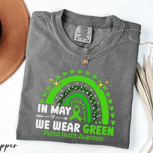 a t - shirt that says in may we wear green
