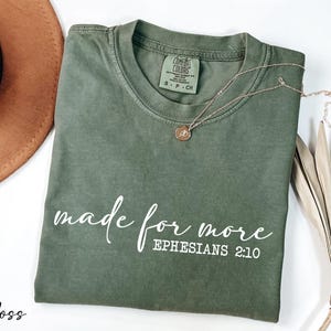 a t - shirt that says made for more ephesians 2010 next to a