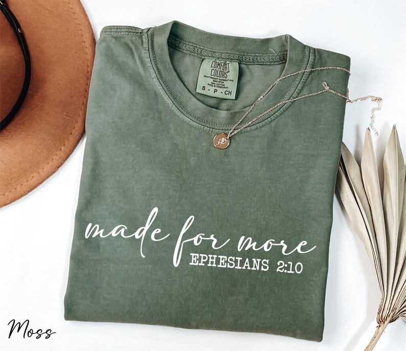 a t - shirt that says made for more ephesians 2010 next to a